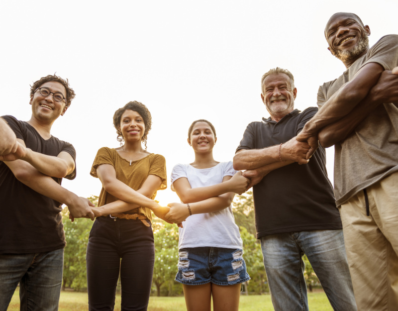 A group of people holding hands in a circle